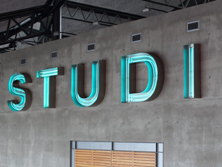 Large blue neon sign at recording studio